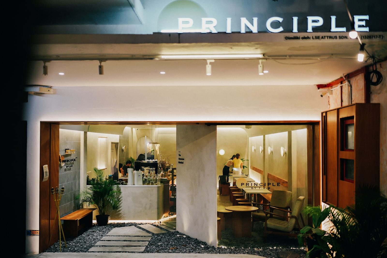 Principle Café on Jalan Trus at night — the PRINCIPLE sign above the open shopfront