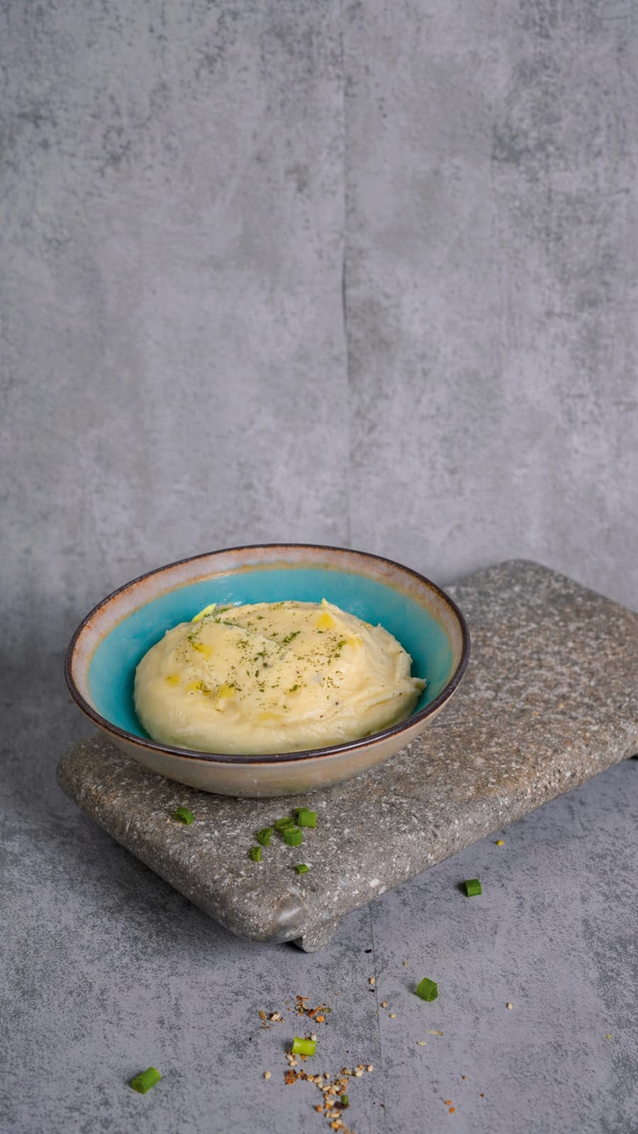 Truffle Mashed Potato in a teal bowl on slate