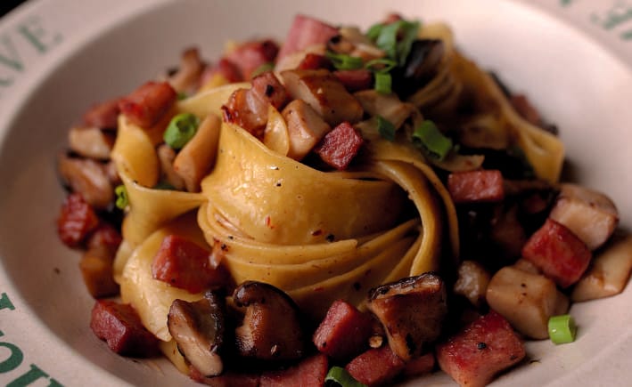 Wide ribbon pasta with mushrooms on a Principle Reserve plate