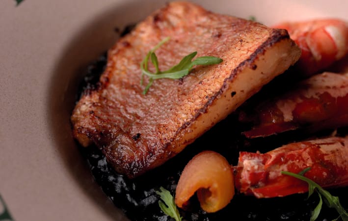 Seared fish over squid-ink risotto with prawns, Principle Reserve
